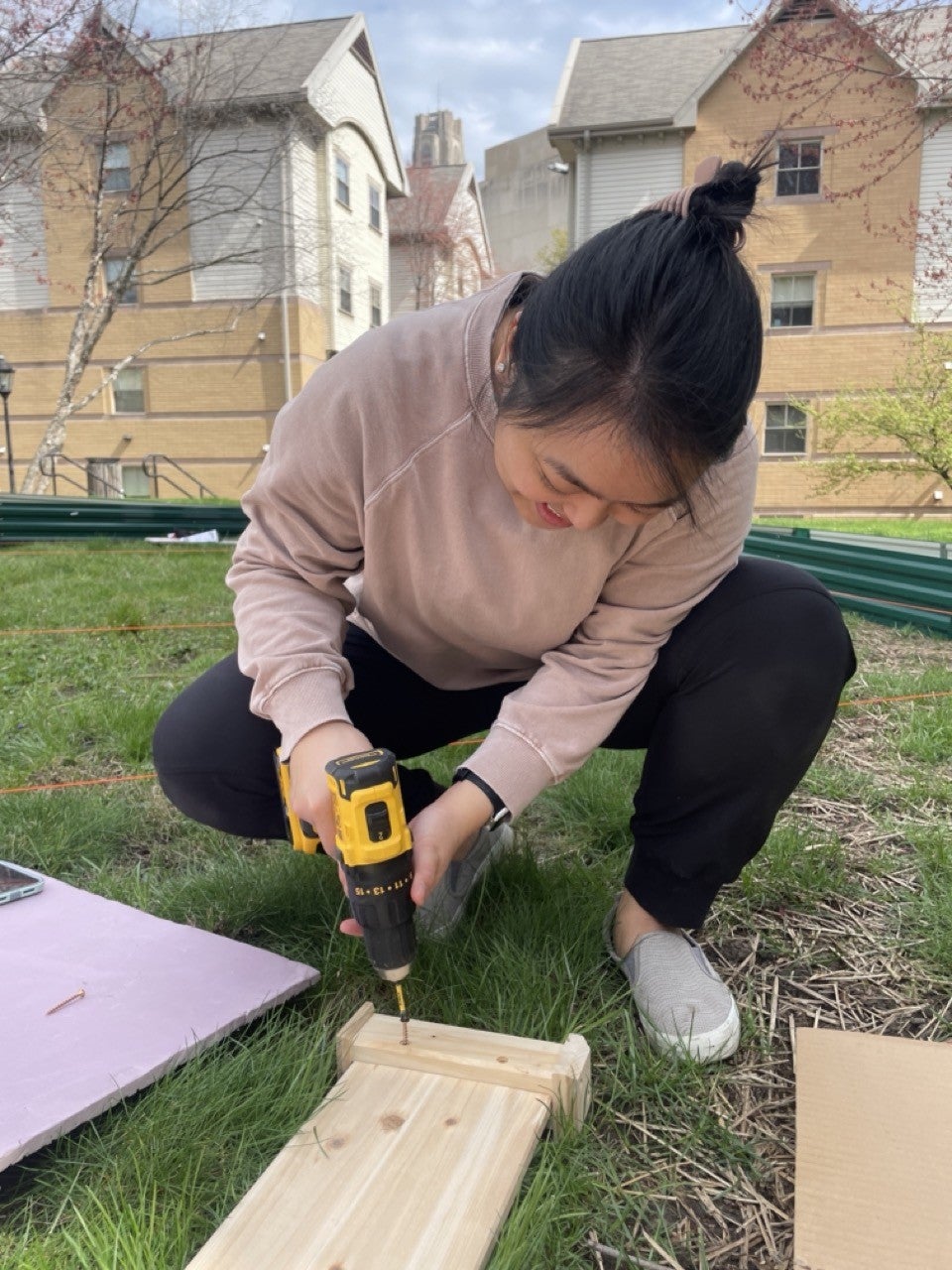 Denica Obis drilling pieces of the planter boxes used for the garden