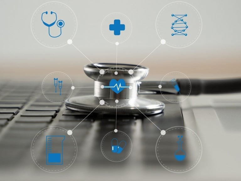 stethoscope on keyboard with icons around it