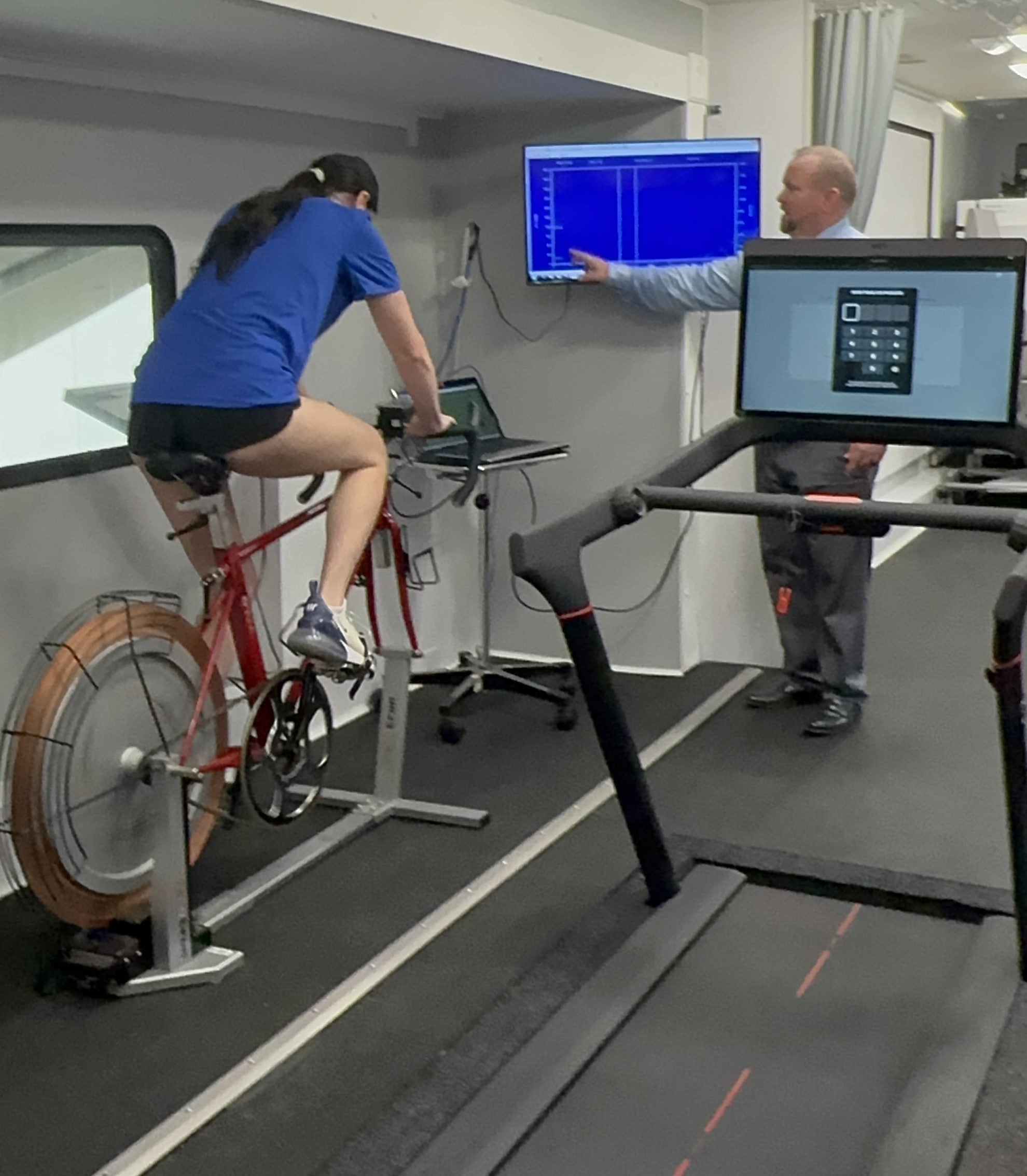 NMRL Associate Director Brian Martin works with an athlete to test performance in the mobile research vehicle laboratory