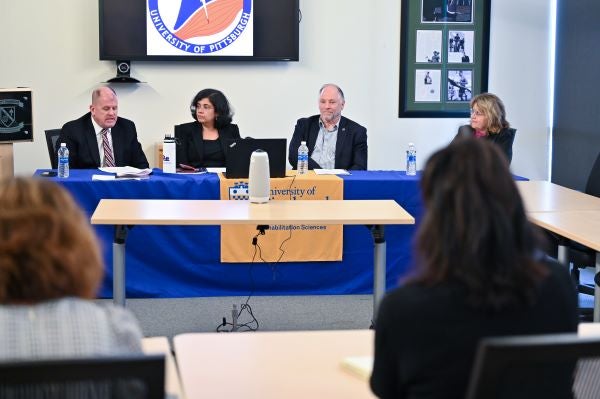 NMRL researchers sitting at table during media roundtable