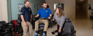 Students and instructors working on a powered wheelchair.