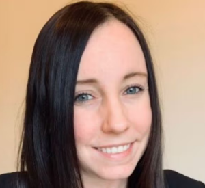 Woman with black hair wearing a black shirt.