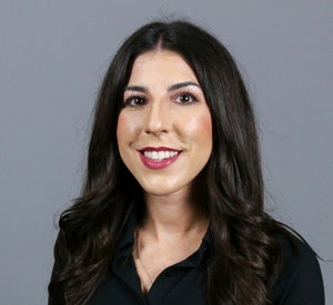 Woman with long, dark brown hair wearing a black blouse.