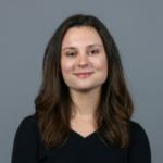 Woman with brown hair wearing a black shirt.