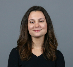 Woman with brown hair wearing a black shirt.