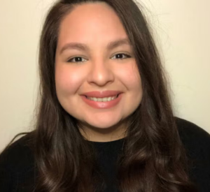 Woman with long dark hair wearing a black shirt.