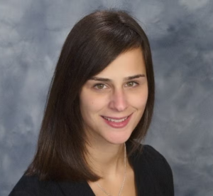 Woman with brown hair wearing a black blouse.