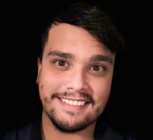 Man with short black hair wearing a black shirt.