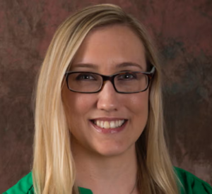 Woman with blonde hair wearing a green blouse.