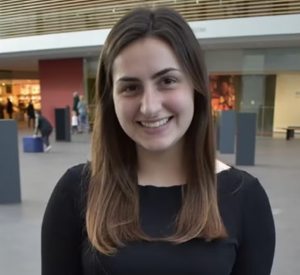 Woman with brown hair wearing a black blouse.