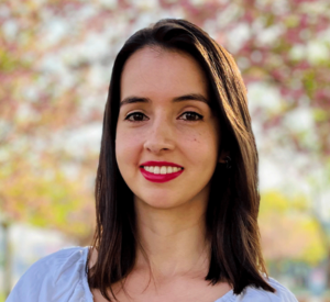 Woman with dark brown hair wearing a light blue shirt.