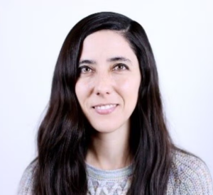 Woman with dark hair wearing a gray sweater.