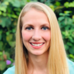 Woman with blonde hair wearing a light blue shirt.