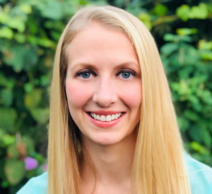 Woman with blonde hair wearing a light blue shirt.