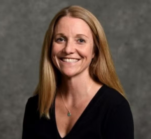 Woman with dark blonde hair wearing a black shirt.