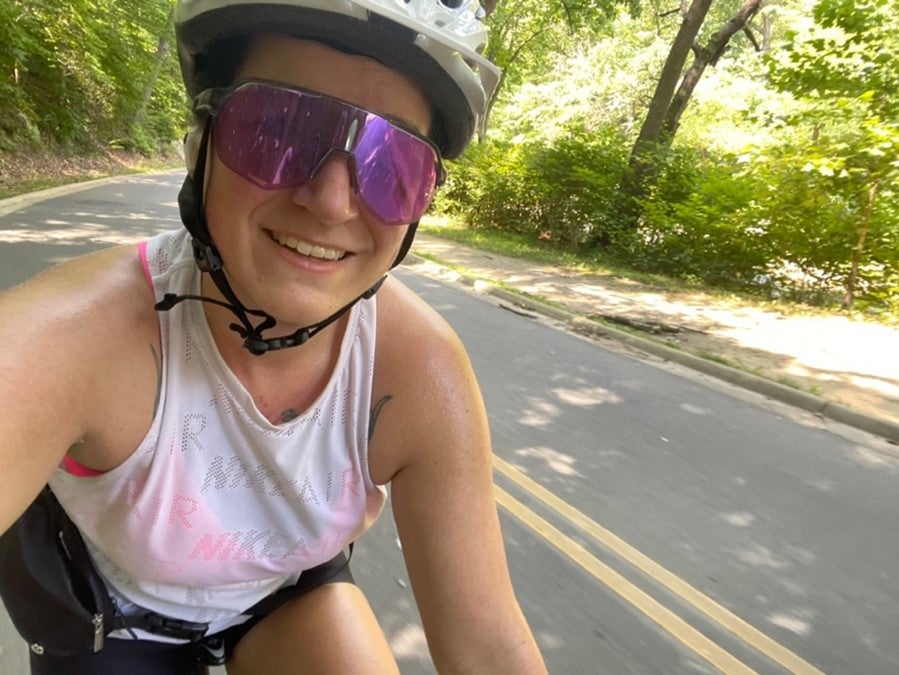 A woman riding a bicycle takes a selfie