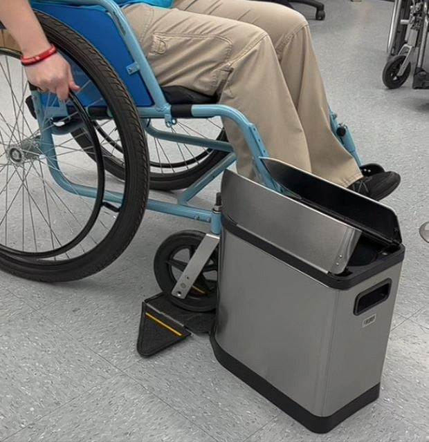 A person sitting in a wheelchair, using the "Just Roll On It" prototype.