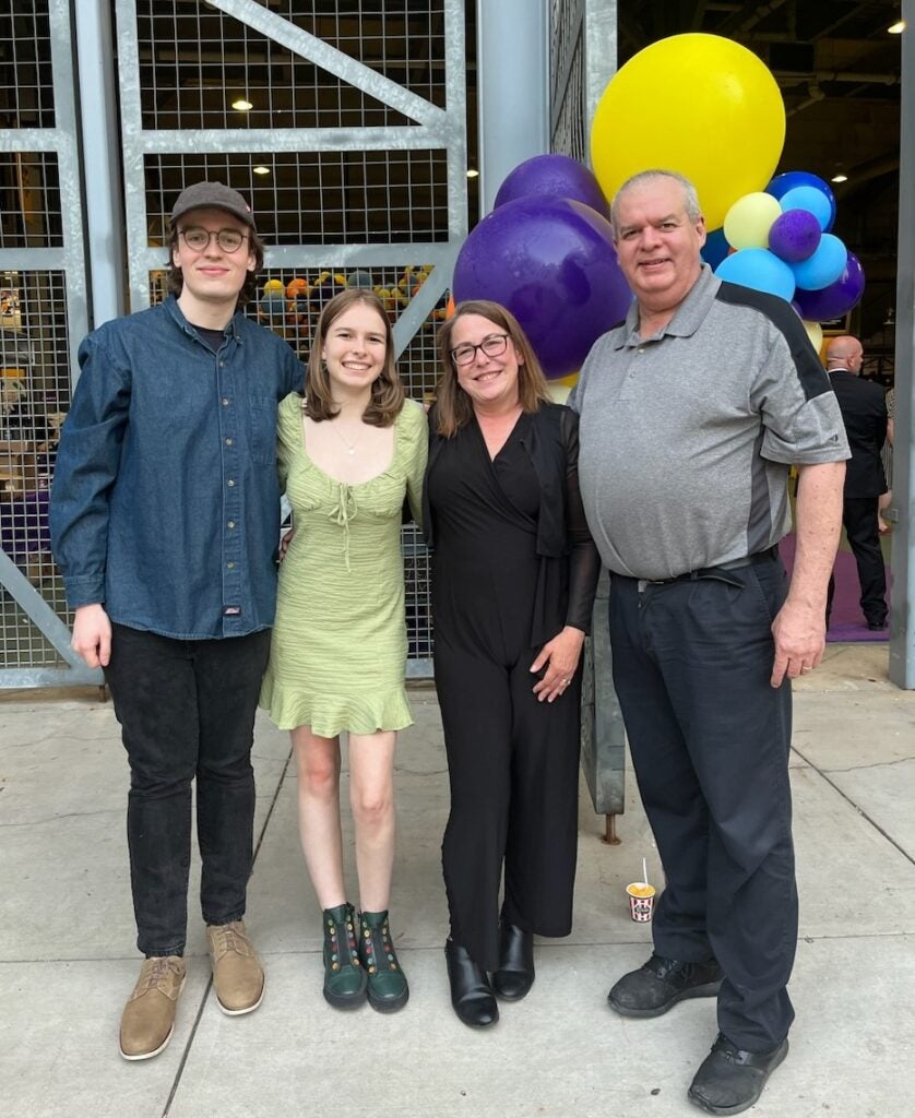 Christine McFarland standing with her family at an event at Acrisure Stadium.