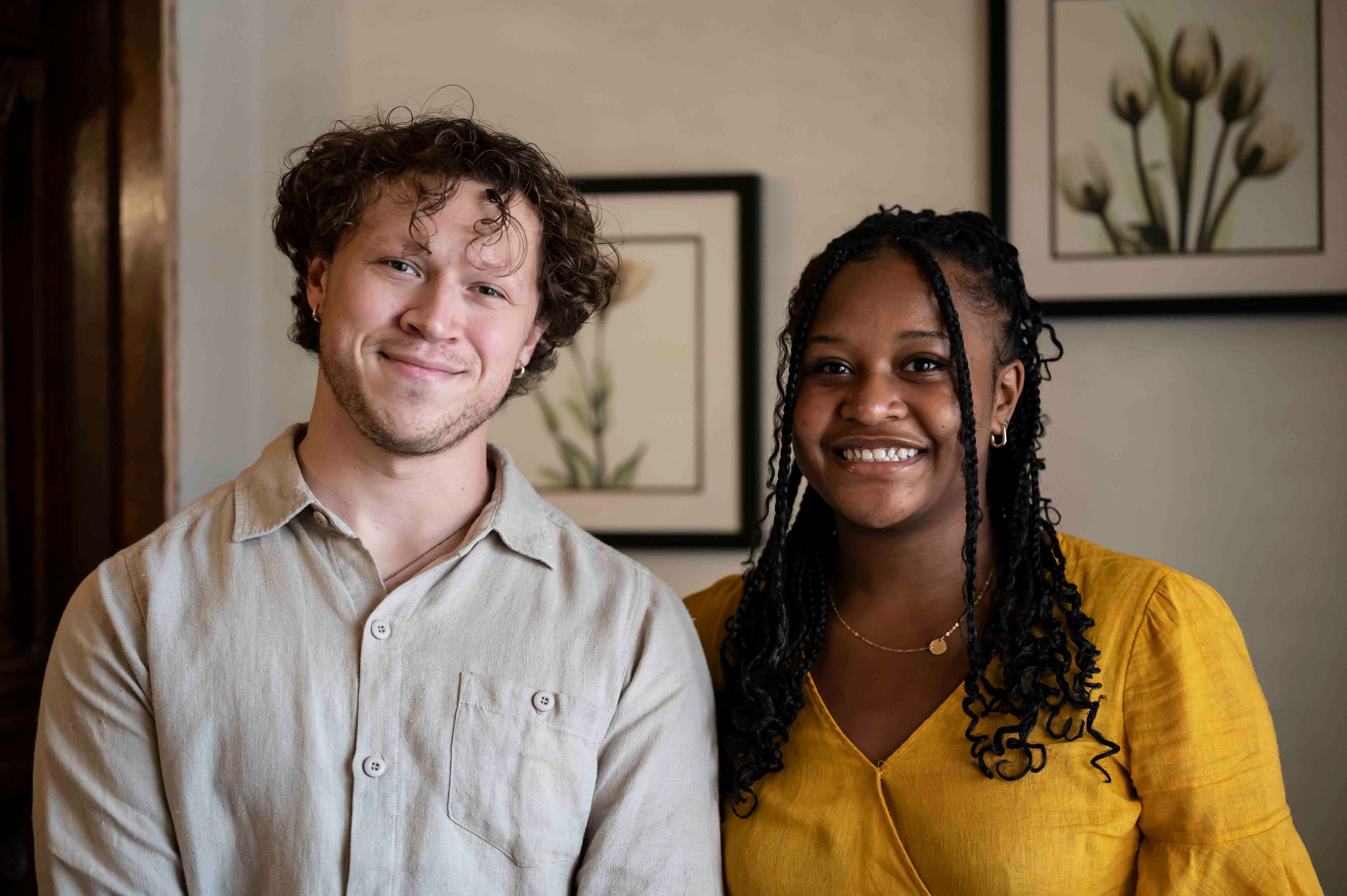 Man and woman standing next to each other posing for a photo.