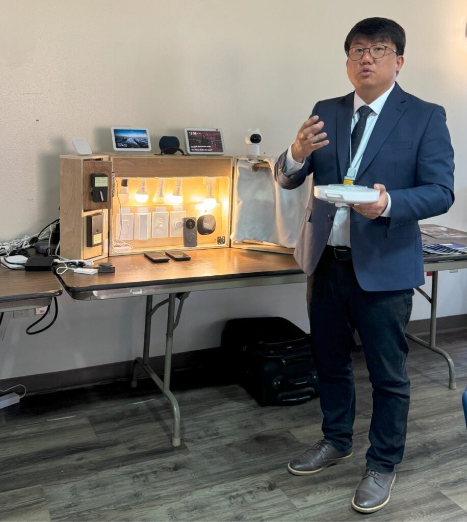 Health Informatics Assistant Professor Yong Choi demonstrates smart home technology.