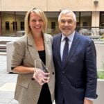 Jennifer White holding award with Dean Anthony Delitto