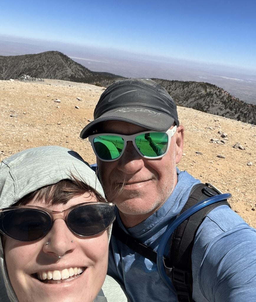 Joel Stevans and his daughter on a Mount Whitney training hike, standing on top of Mount Baldy in California.