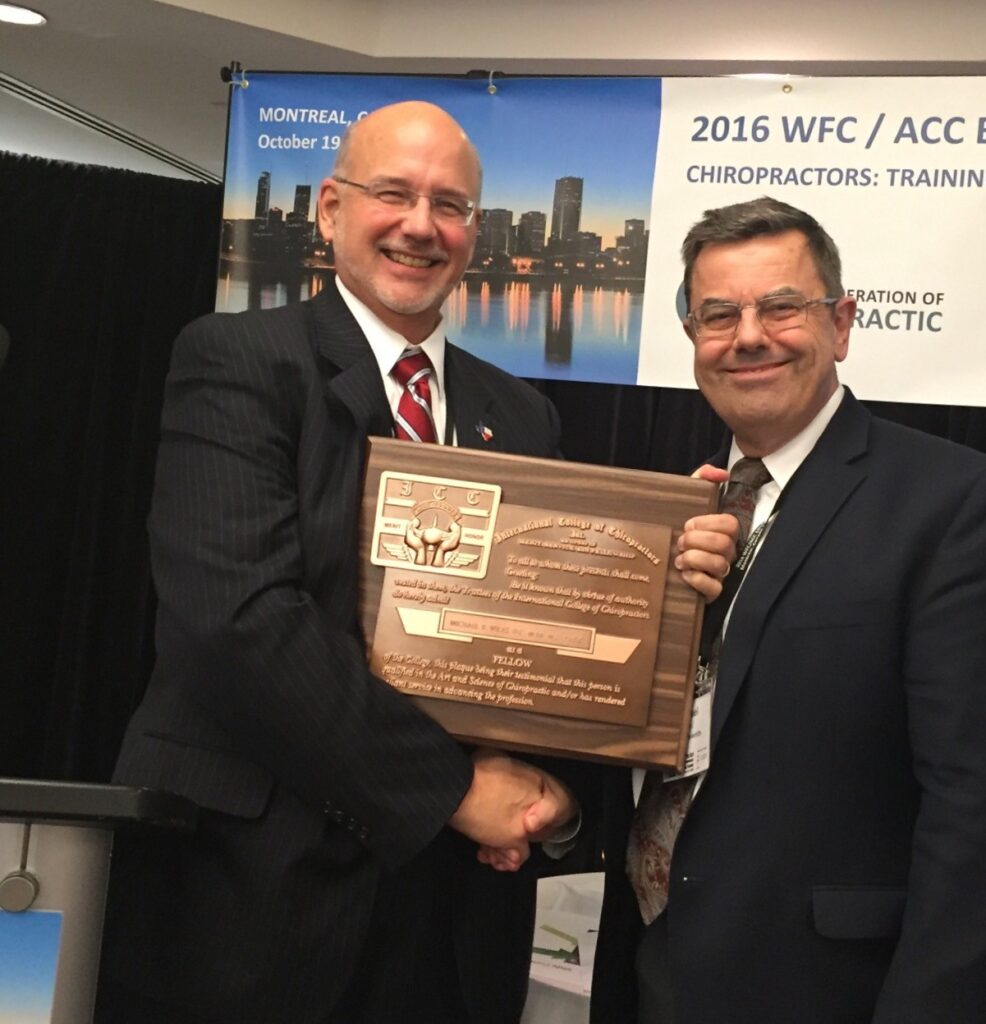 Mike Wiles receiving his Fellow of the International College of Chiropractors plaque at the World Federation of Chiropractic Educational Conference in 2016.