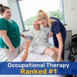 A brunette woman wearing a green scrubs outfit and a blonde woman with a navy blue scrubs outfit helping an elderly man into a bed. Text overlayed onto the image reads "Occupational Therapy Ranked #1"