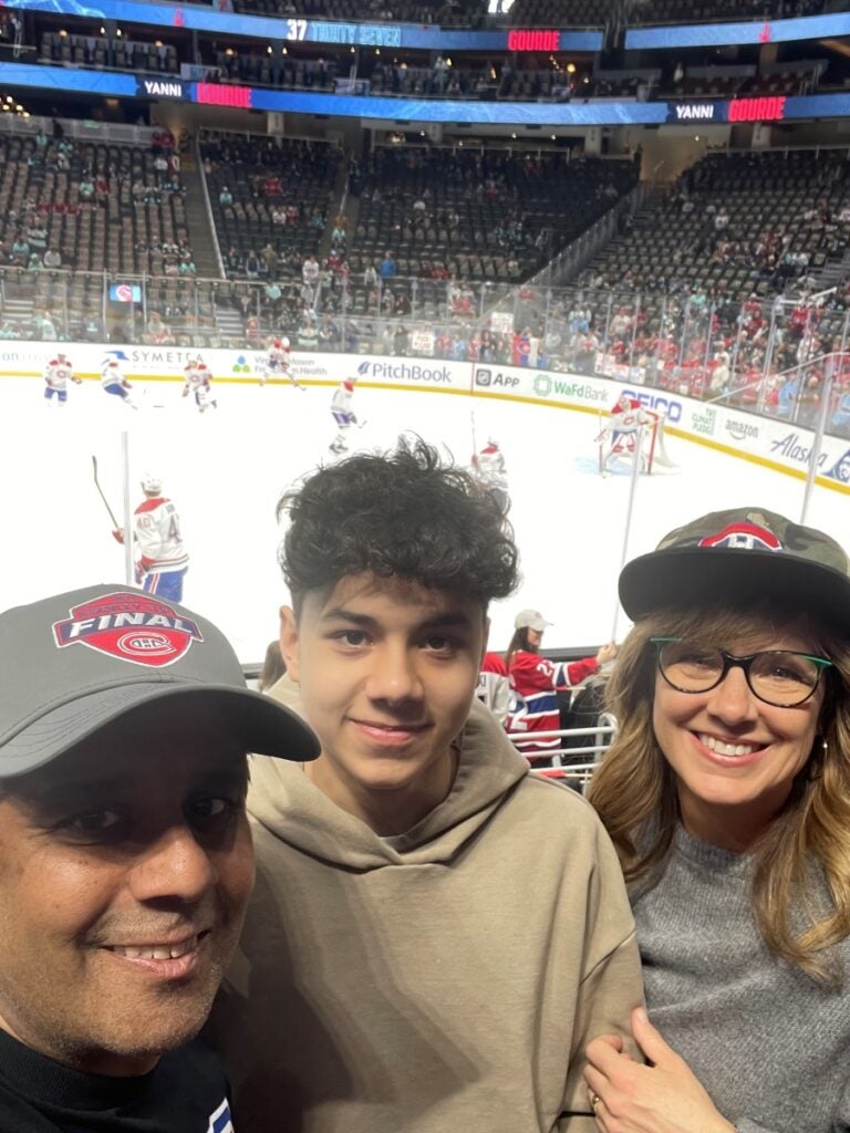 Shireesh Bhalerao with his wife and son at a hockey game.