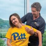 Faculty member demonstrating chiropractic technique on a student's shoulder