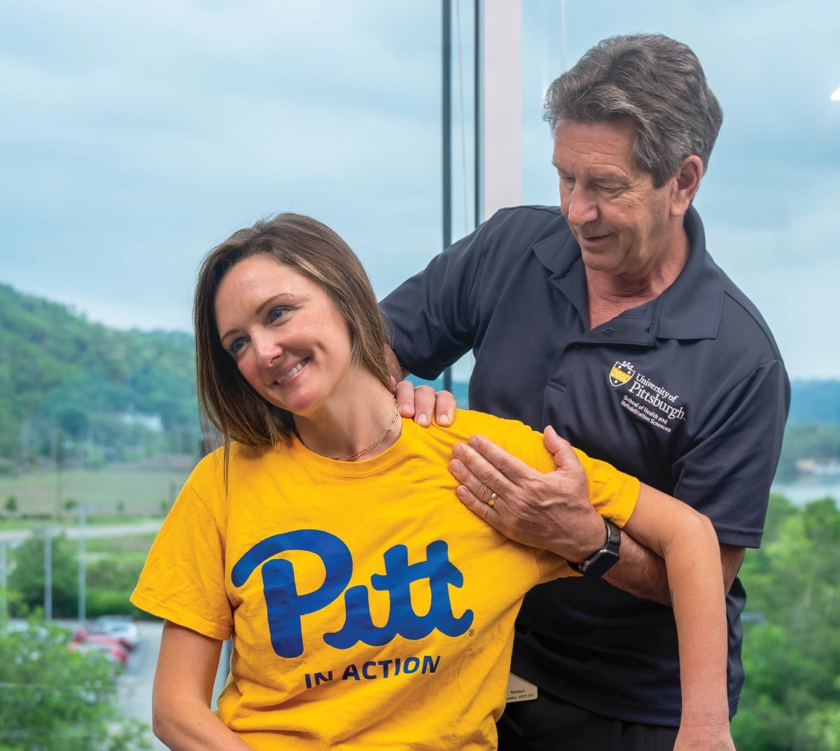 Faculty member demonstrating chiropractic technique on a student's shoulder