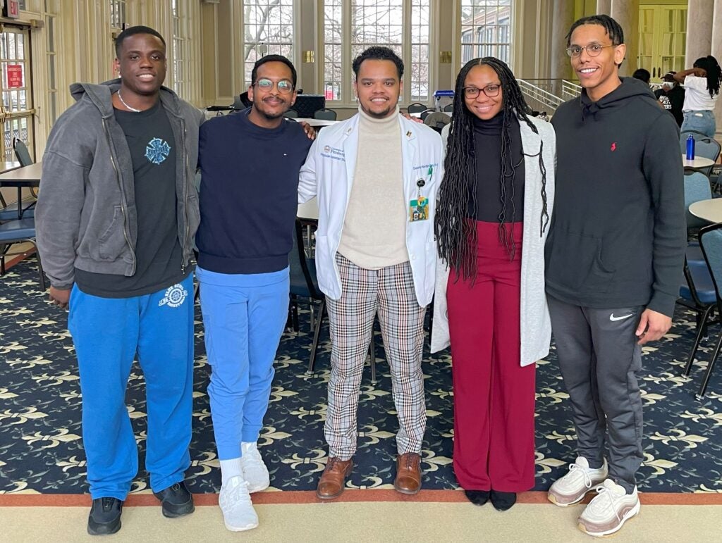 A group of men and women standing together in a student union.